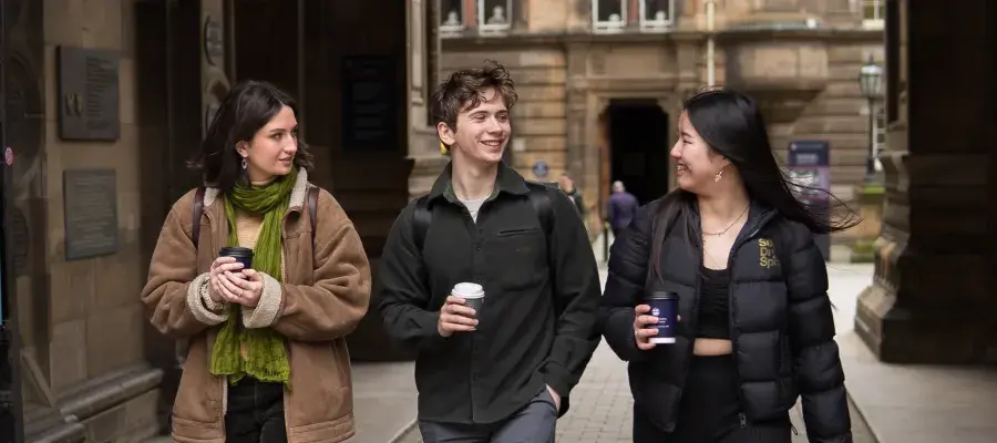 Three students walking outside the Medical Building