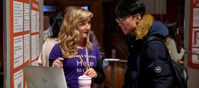 Image of staff and student at a careers fair 