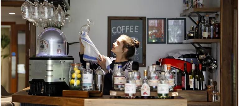 A woman working in a cafe at Pollock Halls campus