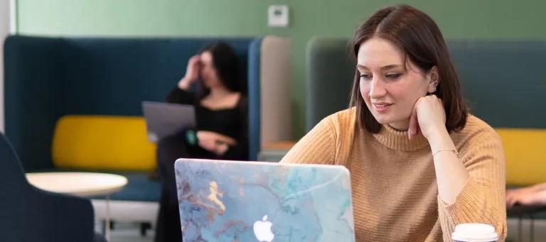 Student sitting at desk on laptop