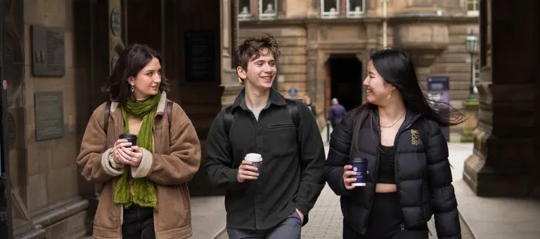 Three students walking outside the Medical Building