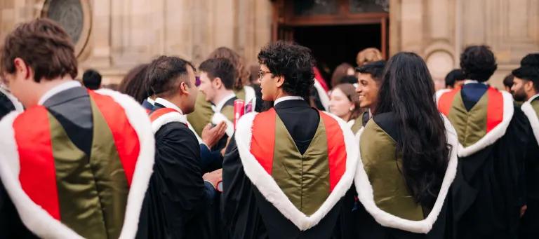 Students at graduation standing facing McEwan Hall