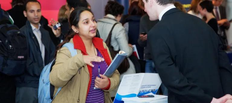 A student talking to a representative from NHS Scotland