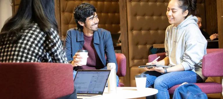 A group of students smiling and talking