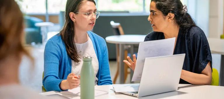 A student and facilitator discussing during a workshop
