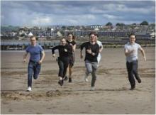 Interns running on the beach