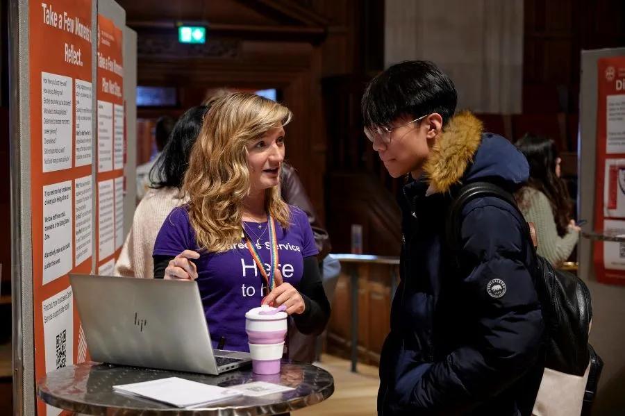 Image of staff and student at a careers fair 
